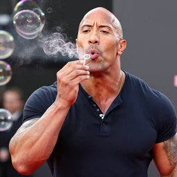 an award winning photo of Dwayne Johnson blowing soap bubbles