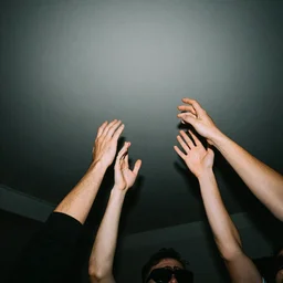 a photo taken with the flash in the dark of arms coming out of the ceiling