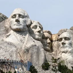 a teddy bear carved as a stone head at mount rushmore