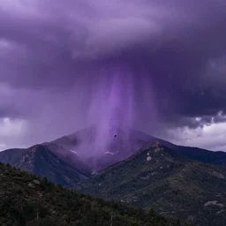 amazing landscape photo of a purple tornad descending on a mountain by marc adamus, beautiful dramatic lighting
