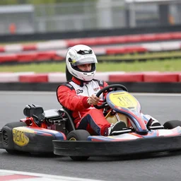 emanuel macron doing a karting race