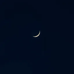 aesthetic night sky with the moon in its crescent form with rings around it