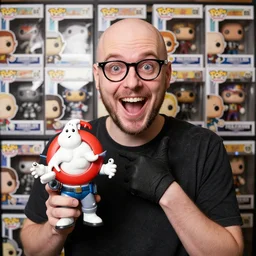 an extremely happy nerdy balding guy surprised in front of his collection of funko pop, holding a female ghostbuster, realistic photo