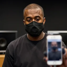 a photo of Kanye West wearing a mask in the studio, 8K concept art, shot on IPhone 6, slightly blurry