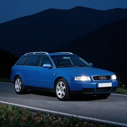 Denim Blue Audi A4 B6 Avant (1997) on a mountain road at night, wide shot