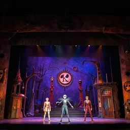 photo of a huge theaterstage, theaterplay is nightmare before christmas, 3 actors on stage, 8 k, multicolored, exaggerated detailed, long shot