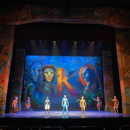 photo of a huge theaterstage, theaterplay is avatar, 3 actors on stage, 8 k, multicolored, exaggerated detailed, long shot