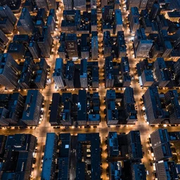 Birds eye view of a metropolis at night, rectangular city grid with narrow streets, tall brutalist architecture buildings, city lights spilling upwards above the top of the buildings,