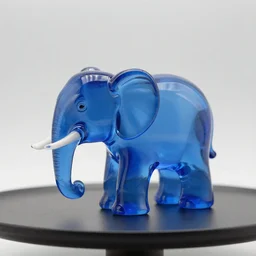 a blue glass elephant statue on a table, studio lighting, caustics,