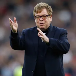 Elton John plays football