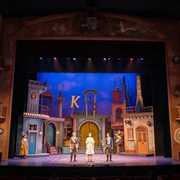 photo of a huge theaterstage, play is who's afraid of virginia woolf, 3 actors on stage, 8 k, multicolored, exaggerated detailed, long shot