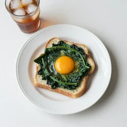 white ceramic plate, garlic bread, spinach garnishing, egg yolks on top, ice tea in glass, food, photograph, breakfast, photorealistic, 4k, top down shot