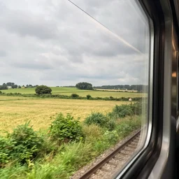 a view of the countryside from a train window, high quality photograph, 8 k, high resolution, landscape photography