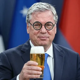 photo of viktor orban wearing round glasses with beer by terry richardson