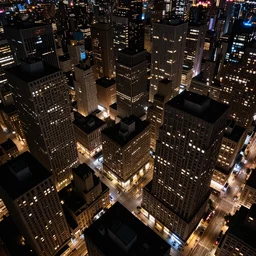 Birds eye view of an oppressive metropolis at night, sparse rectangular city grid with narrow streets, tall brutalist architecture buildings with very few windows all with the same height, city lights spilling upwards above the top of the buildings, digital art,