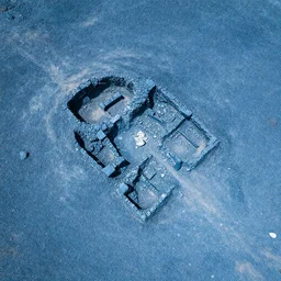 aerial photography  cool blue angular slate rubble, mini traces ancient desert settlement