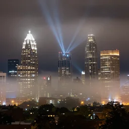 atlanta georgia skyscrapers, night, fog, lights shining beams into fog,