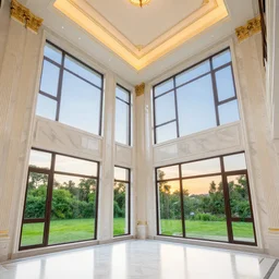 the interior of a house with very high ceilings with white marble walls and floors with gold details with huge windows where you could see the sunset in the greens