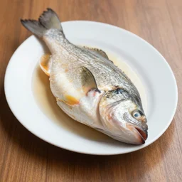 discusting dish of a fish with eye on the floor