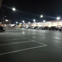 empty parking of a supermarket at midnight taken with a flash, slightly foggy, jpg artifacts, liminal space