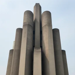 a sci - fi beautiful brutalist hypermodern monument, with many rounded brutalist towers sprouting from the base tower creating a complex and unique geometric building, photography