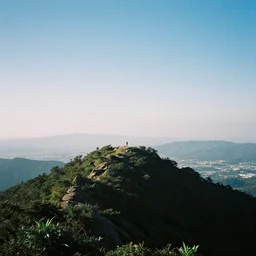 chrome blob on a mountaintop summit, 3 5 mm photography grainy exposed film wide shot panorama