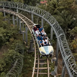 a rollercoaster, tracks of barbed wire, birds eye view, surreal