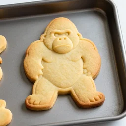 gingerbread cookie shaped like a gorilla on a baking pan, dslr, photography