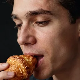 closeup headshot photo of the man tasting a croquette, detailed face details