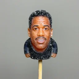 miniature chris rock made of crystallized sugar on a wooden stick