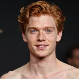 handsome, very pale, ginger man with wavy hair, blue eyes, small nose, thin lips, white teeth, small ears, upper body photograph