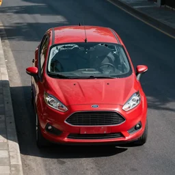 front view red car Ford oxidized, with the broken windshield, in the street