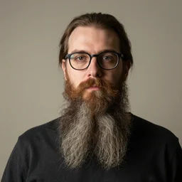 portrait of a man with a long beard and glasses