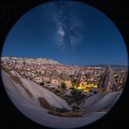 a detailed beautiful matte painting of a Cappadocia, Turkey under a starry night sky, by Mikko Lagerstedt and Raphael Lacoste, fisheye lens