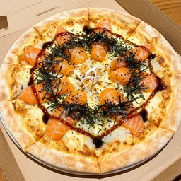 a pizza with soy sauce, rice, raw salmon, and dryed seaweed