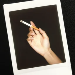 a lomographic photo of woman hand with cigarette