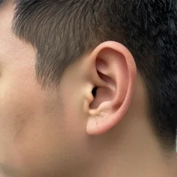 A realistic photo of a man with big ears