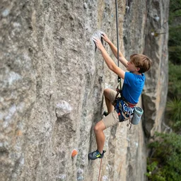 two teenagers rock climbing, photorealistic, hyper detailed, national geographic