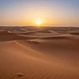 areal photo of winding sunset over sahara desert rolling sand dunes