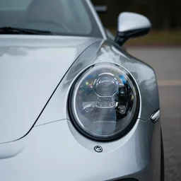 closeup shot of the headlights of a porsche 911