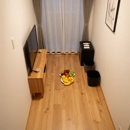 view of inside cramped shibuya apartment with assorted fruit on the floor
