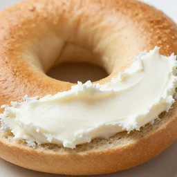 an extreme close up of a new york city style bagel, one half with cream cheese, 80mm macro lens