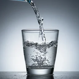 water being poured into a glass. award winning photo