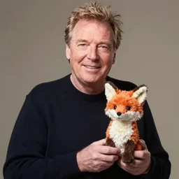 jeremy clarkson holding a toy plush fox