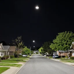 a suburban street with a black ceiling, flood lights