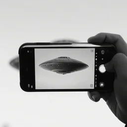 a photograph of a ufo taken by a phone camera, black and white