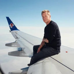jim wilkins artist sitting on a wing of a boeing 7 4 7