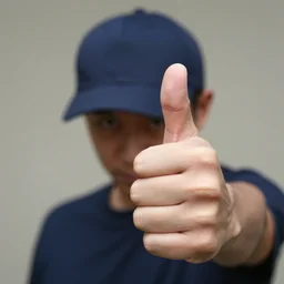 photograph of a thumb that looks like a man wearing a baseball cap