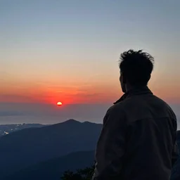 a figure watches epic view of distant red sunset above mountainscape and sea, by Caspar David friedrich