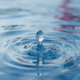 water drop of clear water, reflected on the water it's about to touch ) ) ) ( background : clear water infinity, some bleu, white and red reflections ) provided by unreal engine, hd, 8 k, realism, reality, highly detailed